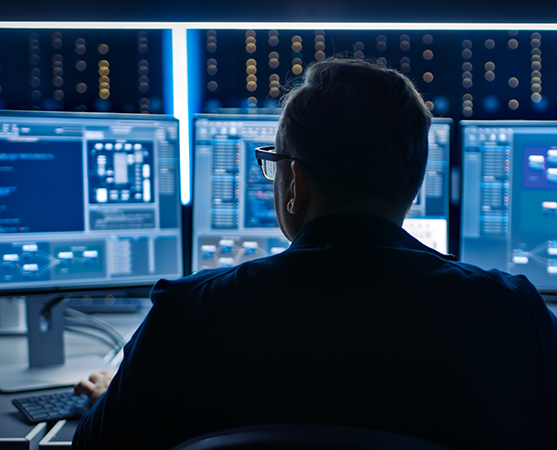 man in front of computer screen cybersecurity attack