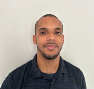Gentleman with facial hair and black collared shirt